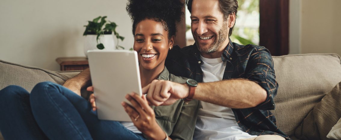 There are so many apps to choose from. a happy young couple using a digital tablet together while relaxing on a couch at home